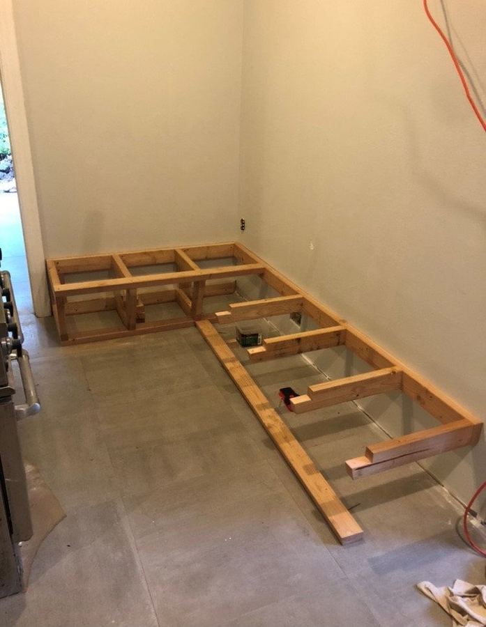 Bench frame being built against a wall
