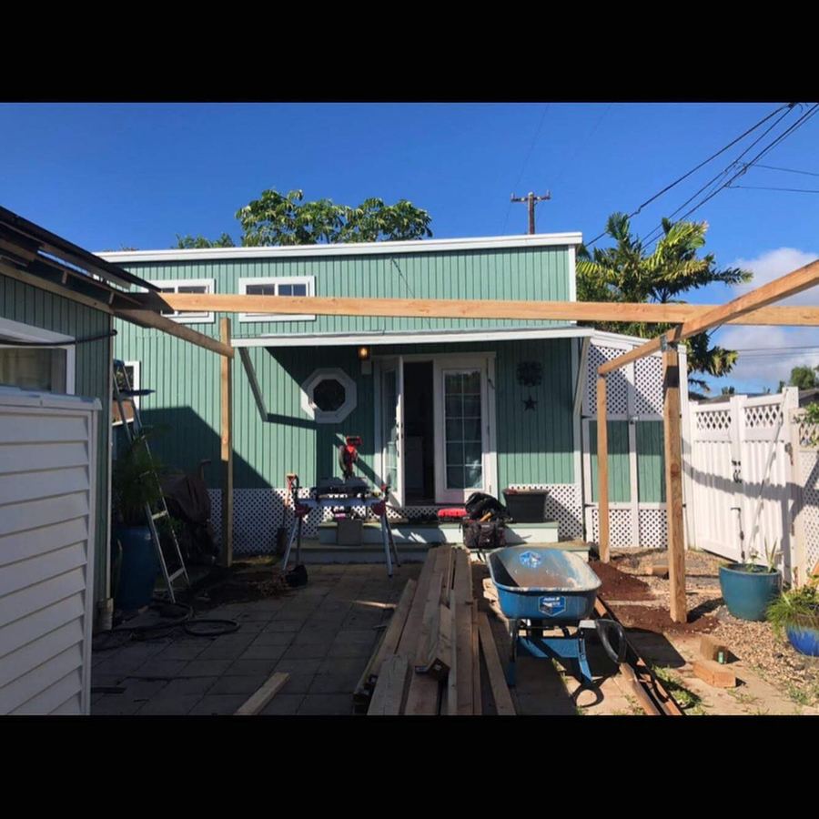 Lanai cover work in progress behind a house
